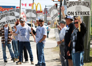 Striking construction workers on picket line in Ontario May 10. Then some 7,000 drywall workers downed their tools, joining 36,000 carpenters and other workers already on strike.
