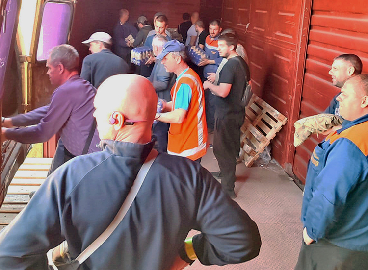 Rail workers load up rail car May 3 in Lviv with food, medicine and other supplies for union members, fellow workers and Ukraine combatants, in areas hardest hit by Moscow’s invasion.