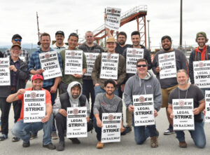 June 20 picket line at Vancouver, British Columbia, rail yard at start of signal workers strike. IBEW members are fighting for wage increases, humane work schedules, safety.