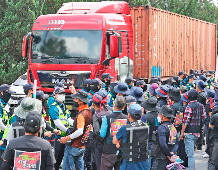Owner-operator truck drivers at Inland Container Base in Uiwang-si, South Korea, fight to stop trucks moving during eight-day nationwide strike that won rate hikes to fight inflation.