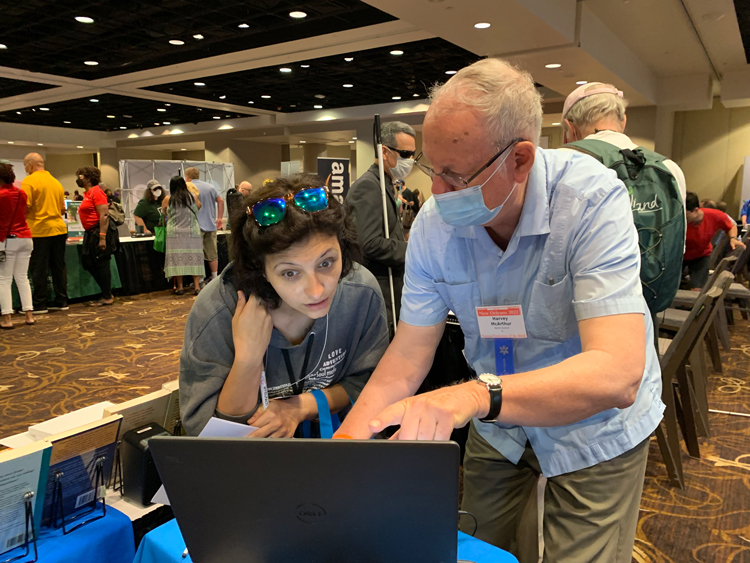 Pathfinder volunteer Harvey McArthur shows Brooke Coelho how accessible e-book files of books by Socialist Workers Party, other revolutionaries can be read by people who are blind.