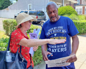 Community activist and retired truck driver Eugene Jenkins gets Militant subscription from Candace Wagner, SWP candidate for governor of Pennsylvania, July 22 in Philadelphia.