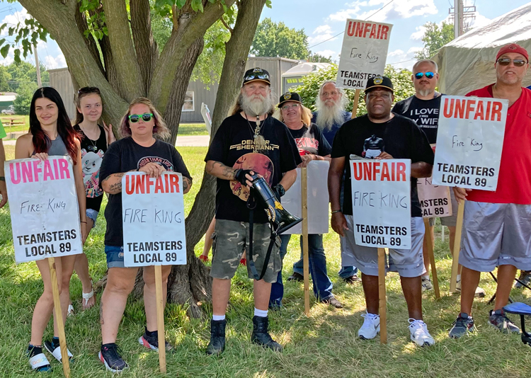 Members of Teamsters Local 69 stand firm on picket line at FireKing, in New Albany, Indiana, July 14. Working conditions, high costs for health insurance sparked first-ever strike there.