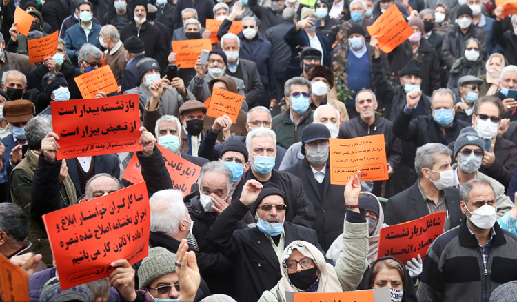 Retirees protest at parliament in Tehran Jan. 17. Placards say, “Employed and retired, unity, unity.”