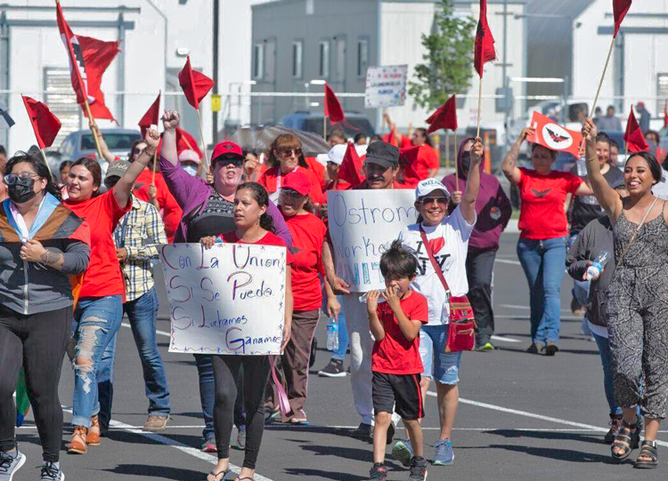 Workers at the Ostrom Mushroom Farm in Sunnyside, Washington, march June 22 with petitions signed by 200 workers to protest bosses’ threats and harassment on the job.