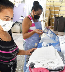 “We’ve had to live with U.S. economic war on Cuba,” say leaders of Federation of Cuban Women. “We’ve done it for decades and still developed.” FMC helped launch home laundry program, like one above in Arroyo Naranjo, near Havana, to provide a much needed service and jobs for women.