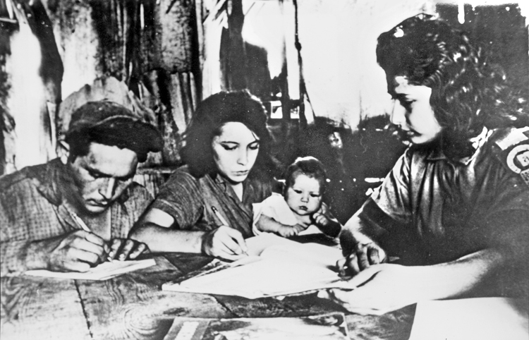 Members of peasant family learn to read and write, 1961. Young women were majority of the 250,000 volunteers who wiped out illiteracy in one year. Women’s determination to participate in revolution broke down barrier after barrier inherited from capitalism, as working people gained confidence in their own capacities.