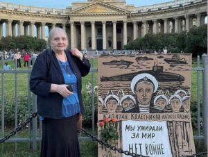 Artist Yelena Osipova protests in St. Petersburg July 31, celebrated in Russia as Navy Day. “We died for peace,” placard says, referring to war against Nazi invasion. “No to War” in Ukraine!