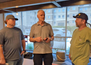BSNF rail worker Gary Cockerham, right, told SWP member Dennis Richter, center, in Ft. Worth Sept. 20 about how crew cuts and increasingly longer trains make rail work more dangerous.