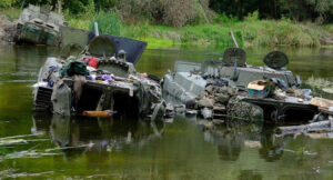 Russian armored vehicles abandoned in river by demoralized troops in Kharkiv region fleeing Ukraine offensive. Russian-led forces, deeply dispirited by lack of support from Ukrainians in cities they occupied, departed in disarray, surrendered or deserted.