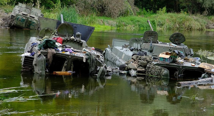 Russian armored vehicles abandoned in river by demoralized troops in Kharkiv region fleeing Ukraine offensive. Russian-led forces, deeply dispirited by lack of support from Ukrainians in cities they occupied, departed in disarray, surrendered or deserted.