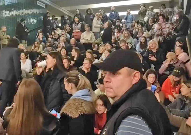 Ukrainians take refuge in Kyiv metro station during Russian missile assault Oct. 9, singing national anthem. Lina Malina said fellow Ukrainians, her people, are a “nation of invincibles.”