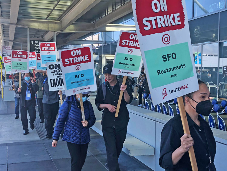 UNITE HERE Local 2 members picket San Francisco airport Sept. 26, during three-day strike. Workers won wage raise, prevented bosses from increasing family health care costs.