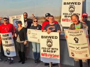 Members of Brotherhood of Maintenance of Way Employees, supporters, picket with information about their rail contract fight on bridge over BNSF rail yard in Lincoln, Nebraska, Nov. 2.
