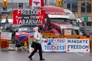 Truckers protest in Canada’s capital Feb. 8, demanding an end to vaccine mandates that threaten their livelihoods. Trudeau gov’t invoked Emergencies Act to crush protest, imprison leaders. 