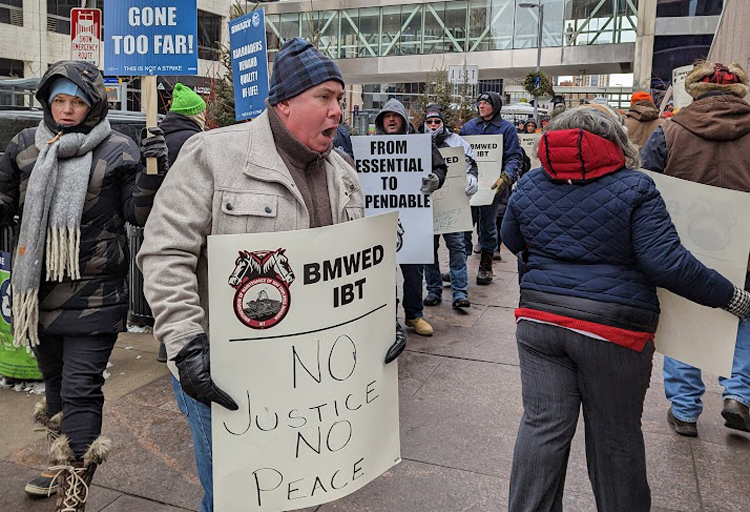 Rail workers in Brotherhood of Maintenance of Way union picket Feb. 3 at Canadian Pacific office in Minneapolis. They are demanding higher wages, paid sick days, pay for travel, housing when working away and improved safety on the job. It was same day as derailment in Ohio. 