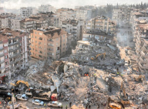 Collapsed buildings in Hatay, Turkey, after Feb. 6 earthquakes. Tens of thousands of people died and millions are homeless in Turkey and Syria because of for-profit building construction.