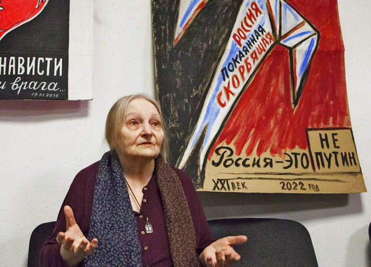 Art exhibit by Elena Osipova, above, in St. Petersburg, Russia, Jan. 31. Poster says, “Russia, repentant, grieving. Russia is not Putin.” In face of Putin’s police repression, “flower protests” against bombardment of Ukraine cities, one-person pickets and graffiti continue to proliferate.