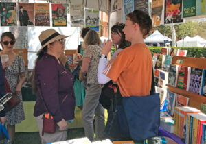 Visitors to Pathfinder booth at Festival of Books in Los Angeles April 22-23 bought 235 books, 86 Militant subscriptions. Laura Garza, left, talks with Sam Frank, right, and Evelyn Holman.