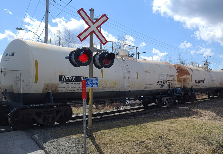 Tanker cars running through Lac-Mégantic April 2022. Trains carry toxic chemical vinyl chloride, like in Feb. 3 toxic derailment in East Palestine, Ohio. “Canadian Pacific, responsible for 2013 tragedy, will get $1 billion” for bypass, said Robert Bellefleur of committee for rail safety.