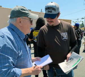 SWP member Norton Sandler, left, with UPS driver Andrew Jones at Teamsters rally in Orange, California, April 15. Jones got a Militant subscription and a copy of Teamster Rebellion.