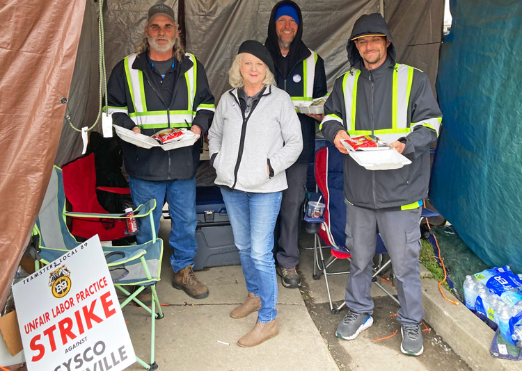 In Louisville, retired teacher Mary Thurman joins Sysco pickets April 6 with hot lunches she brought as an act of solidarity. Teamsters voted by 98% to approve new contract.