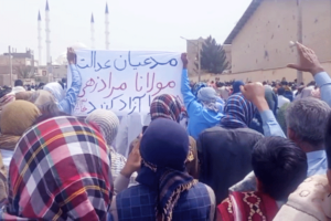 May 5 march in Zahedan, in Baluchistan province in Iran, marks 32nd consecutive weekly protest there, called for end to death penalty and for freeing political prisoners. Banner says “You who claim to be for justice, free Maulana Moradzehi,” an imprisoned Sunni cleric.