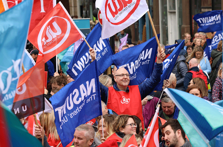 Thousands of teachers and other public sector workers rally at Belfast City Hall in Northern Ireland on April 26 dur-ing one-day strike for higher wages, staffing and working conditions.