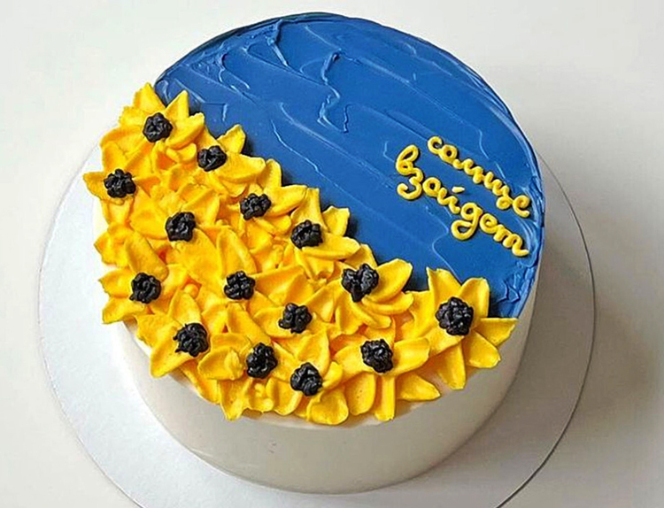 Anastasia Chernysheva was fined for “discrediting” Russian military by posting online image of a cake in blue-and-yellow icing, colors of Ukraine’s flag. It says, “The sun will rise,” from song in a famous Soviet-era cartoon, “the night will be over with the hard times, the sun will rise.”