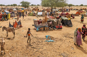 Sixty thousand Sudanese refugees camped in neighboring Chad after fleeing fighting since April. Inset, smoke rises over Khartoum, Sudan’s capital, during military clashes May 1.