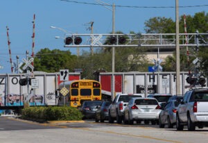 Freight train blocks traffic at Vero Beach, Florida, rail crossing March 2. Note that crossing gates remain upright as the train passes. Such faults add to inherent dangers of unprotected crossings.