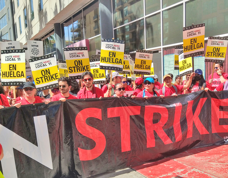 Striking UNITE HERE Local 11 members march in Los Angeles July 21. “Strikes can happen anytime, anyplace,” Kurt Petersen, co-president of the Local, said of the union’s rolling walkouts.