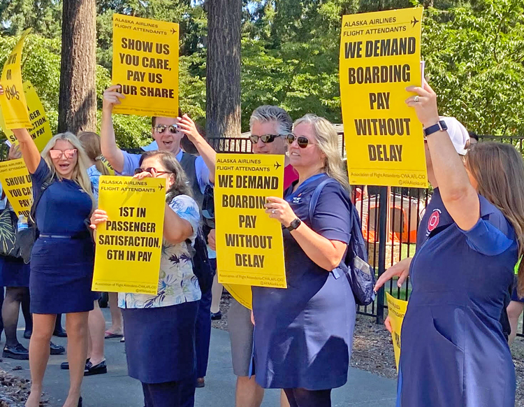 Flight attendants at Alaska Airlines rallied outside company headquarters at Sea-Tac airport in Washington Aug. 15. Unionists demand new contract with full pay for all the hours they work.
