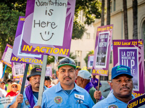 Over 11,000 Los Angeles city workers, including sanitation and airport workers, mechanics, gardeners and lifeguards, held 24-hour strike Aug. 8, protesting understaffing and overwork.