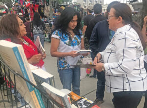 Laura Garza, right, Socialist Workers Party candidate for U.S. Senate from California, discusses politics with participants at Mexican Independence Day celebration in Oxnard Sept. 17.