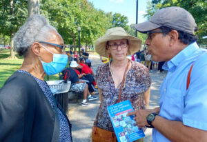 Róger Calero, Socialist Workers Party candidate for New York City Council, Joanne Kuniansky, center, running for New Jersey State Senate, discuss party’s program with participants at march.