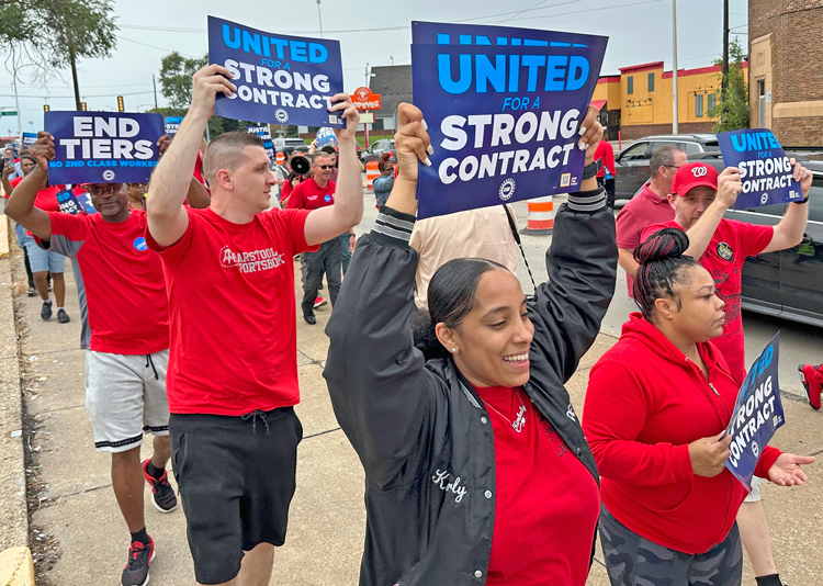 United Auto Workers members ‘practice picketing’ near a Stellantis factory in Detroit, Aug. 23. Union demands big wage raise, end to divisive two-tiers, restoring cost-of-living protection.