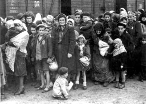 Jewish women and children being transported to Auschwitz death camp in 1944. Nazi Holocaust murder machine killed over 6 million Jews, two out of three Jews living in Europe.