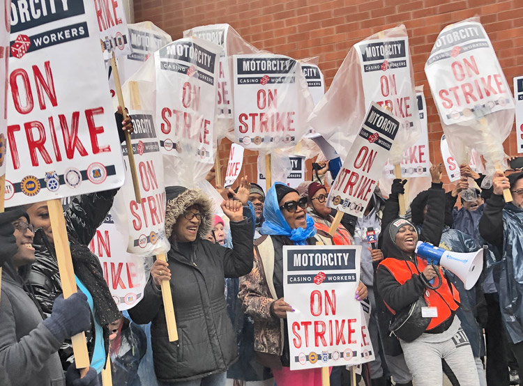 Hundreds of strikers from Detroit’s three big casinos march through the city Oct. 19. The 3,700 workers on strike are demanding higher wages, protection of health care benefits.