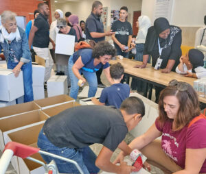 Arabs, Jews work together packing food, toiletries Nov. 8 at community center in Rahat, Israel, for thousands of Bedouin, Jewish Israelis, jobless in Negev after Hamas pogrom Oct. 7.