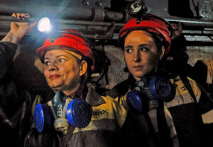 Natalia and Krystyna take elevator Nov. 17 to work underground in the Pavlohradska coal mine in eastern Ukraine. This is first time in decades women won right to work down in the mines.