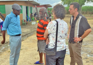Militant reporters from the U.S. and Canada, right, visited the Batey Marchena sugarcane community in La Romana province, Dominican Republic, Nov. 11. Left, Jesús Núñez, national coordinator of Sugarcane Workers Union, describes their fight for pensions, health care, raises.