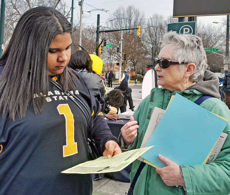 At Atlanta Martin Luther King Day rally Jan. 15, Zoey Johnson, left, bought a Militant after discussion with Lisa Potash, SWP candidate for U.S. Congress, about need to fight Jew-hatred.