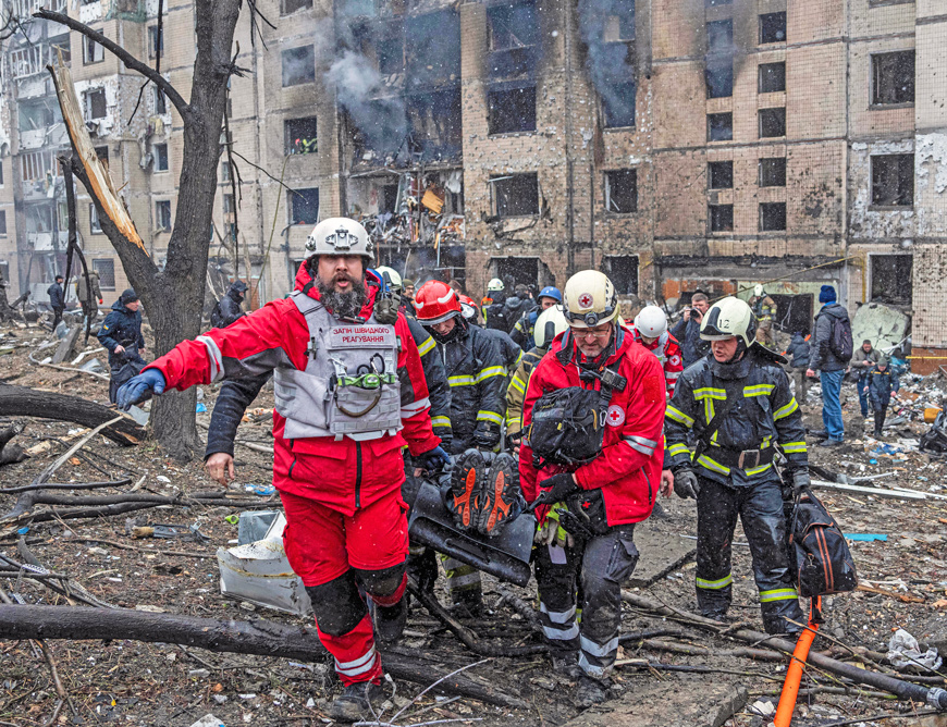Volunteer rescue workers carry survivor from building hit by Russian rocket attack in Kyiv, Ukraine, Jan. 2. Invasion of Ukraine by Russian President Vladimir Putin in February 2022 shook imperialist world “order,” accelerating war preparations by capitalist powers worldwide.