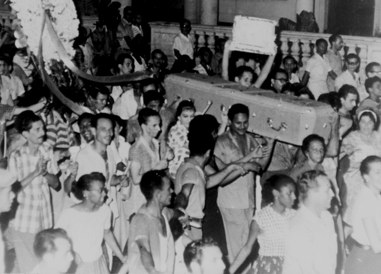 Workers in Havana, August 1960, demonstrate support for Cuba’s revolutionary government’s nationalization of U.S. banks, businesses, represented by coffins thrown into sea.
