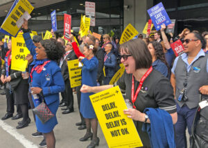 Over 350 flight attendants rallying at San Francisco airport Feb. 13 cheered when they heard that 99.48% of fellow workers at Alaska Airlines voted to authorize strike action. Workers from International Association of Machinists and Teamsters at the airport joined picket in solidarity.