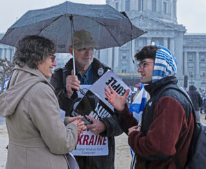 , Socialist Workers Party presidential candidate Rachele Fruit speaks with protesters.