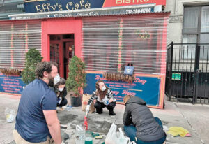 Volunteers remove “Form line here to support genocide” graffiti from sidewalk in front of Effy’s Café after Jew-hating attack on Israeli-owned restaurant in New York City March 16