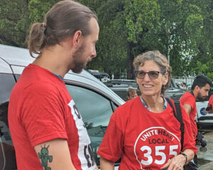 Rachele Fruit, SWP candidate for president and member of UNITE HERE Local 355, with shop steward Nick Lenzi at rally for higher wages for Sky Chef workers in Miami Oct. 11, 2023.