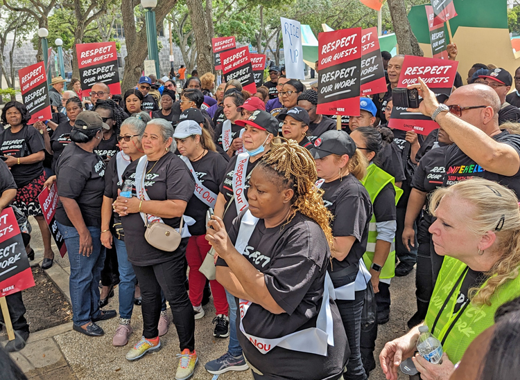 Above, UNITE HERE Local 355 hotel workers rally on International Workers Day in Miami May 1. Inset, Rachele Fruit, right, SWP candidate for U.S. president and a member of the local, and Fruit’s co-worker were among 150 joining the action. Unions, immigrant rights fighters held protests, rallies around the world.